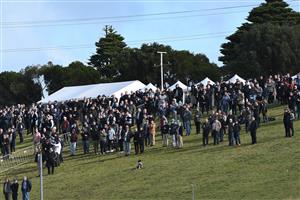 WARRNAMBOOL, AUSTRALIA - MAY 04: General view of racegoers on the hill in Race 6, the 3yb Scotty Stewart Brierly Steeplechase, on Brierly Day during the Warrnambool Jumps Carnival at Warrnambool Racing Club on May 04, 2021 in Warrnambool, Australia. (Photo by Vince Caligiuri/Getty Images)