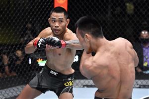 LAS VEGAS, NEVADA - MAY 22: In this handout image provided by UFC, (L-R) Josh Culibao of Australia punches Shayilan Nuerdanbieke of China in their featherweight bout during the UFC Fight Night event at UFC APEX on May 22, 2021 in Las Vegas, Nevada. (Getty Images)