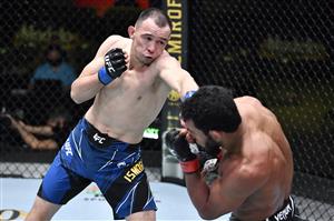 LAS VEGAS, NEVADA - MAY 22: In this handout image provided by UFC, (L-R) Damir Ismagulov of Russia punches Rafael Alves of Brazil in their lightweight bout during the UFC Fight Night event at UFC APEX on May 22, 2021 in Las Vegas, Nevada. (Getty Images)