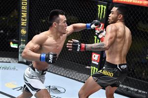 LAS VEGAS, NEVADA - MAY 22: In this handout image provided by UFC, (L-R) Shayilan Nuerdanbieke of China punches Josh Culibao of Australia in their featherweight bout during the UFC Fight Night event at UFC APEX on May 22, 2021 in Las Vegas, Nevada. (Getty Images)