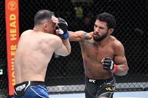 LAS VEGAS, NEVADA - MAY 22: In this handout image provided by UFC, (R-L) Rafael Alves of Brazil punches Damir Ismagulov of Russia in their lightweight bout during the UFC Fight Night event at UFC APEX on May 22, 2021 in Las Vegas, Nevada. (Getty Images)