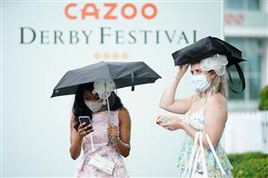 EPSOM, ENGLAND – JUNE 4: Racegoers arrive during day one of the Cazoo Derby Festival at Epsom Racecourse on June 4, 2021 in Epsom, England. (Photo by John Walton-Pool/Getty Images)
