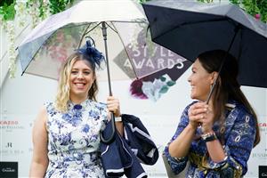 EPSOM, ENGLAND – JUNE 4: Racegoers use umbrellas to shelter from the rain during day one of the Cazoo Derby Festival at Epsom Racecourse on June 4, 2021 in Epsom, England. (Photo by John Walton-Pool/Getty Images)