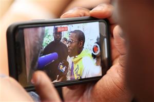 MIAMI BEACH, FLORIDA - JUNE 03: A phone is used to record Floyd Mayweather taking part in media availability ahead of his June 6th exhibition boxing match against Logan Paul on June 03, 2021 at Villa Casa Casuarina at the former Versace Mansion in Miami Beach, Florida. (Getty Images)