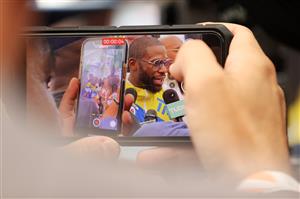 MIAMI BEACH, FLORIDA - JUNE 03: A phone is used to record Floyd Mayweather taking part in media availability ahead of his June 6th exhibition boxing match against Logan Paul on June 03, 2021 at Villa Casa Casuarina at the former Versace Mansion in Miami Beach, Florida. (Getty Images)