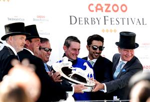 EPSOM, ENGLAND - JUNE 05: Trainer Charlie Appleby (second left), jockey Adam Kirby (centre), managing director of Godolphin Hugh Anderson (right) and the winning connections celebrate with the trophy after Adayar wins the Cazoo Derby during day two of the Cazoo Derby Festival at Epsom Racecourse on June 5, 2021 in Epsom, England. (Photo by John Walton-Pool/Getty Images)