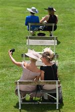 Racegoers sit on socially distanced seating as they wait for racing to start on the second day of the Epsom Derby Festival horse racing event at Epsom Downs Racecourse in Surrey, southern England on June 5, 2021. (Photo by Glyn KIRK / AFP) (Photo by GLYN KIRK/AFP via Getty Images)