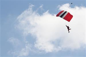 A member of the Red Devils parachute display team of the British Army's Parachute Regiment is seen above the course on the second day of the Epsom Derby Festival horse racing event at Epsom Downs Racecourse in Surrey, southern England on June 5, 2021. (Photo by Glyn KIRK / AFP) (Photo by GLYN KIRK/AFP via Getty Images)