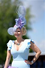 EPSOM, ENGLAND - JUNE 05: A racegoer arrives for day two of the Cazoo Derby Festival at Epsom Racecourse at Epsom Racecourse on June 5, 2021 in Epsom, England. (Photo by John Walton - Pool/Getty Images)