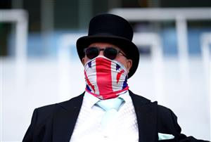 EPSOM, ENGLAND - JUNE 05: A racegoer wears a Union Jack face covering during day two of the Cazoo Derby Festival at Epsom Racecourse on June 5, 2021 in Epsom, England. (Photo by John Walton - Pool/Getty Images)