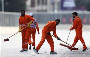 BAKU, AZERBAIJAN - JUNE 06: Track marshals sweep the track during a yellow flag period after a crash for Lance Stroll of Canada driving the (18) Aston Martin AMR21 Mercedes during the F1 Grand Prix of Azerbaijan at Baku City Circuit on June 06, 2021 in Baku, Azerbaijan. (Getty Images)