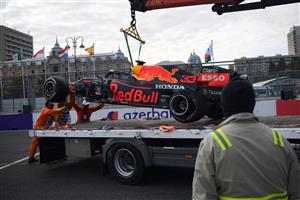 Marshals remove the car of Red Bull's Dutch driver Max Verstappen from the track after a crash during the Formula One Azerbaijan Grand Prix at the Baku City Circuit in Baku on June 6, 2021. (Getty Images)