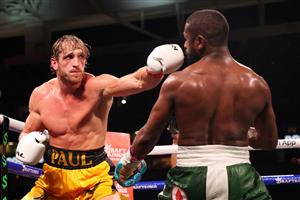 MIAMI GARDENS, FLORIDA - JUNE 06: Logan Paul (L) punches Floyd Mayweather during their contracted exhibition boxing match at Hard Rock Stadium on June 06, 2021 in Miami Gardens, Florida. (Getty Images)