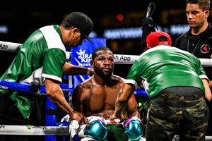 Former world welterweight king Floyd Mayweather sits in the corner in between rounds in an eight-round exhibition bout against YouTube personality Logan Paul at Hard Rock Stadium in Miami, Florida on June 6, 2021 (Getty Images)