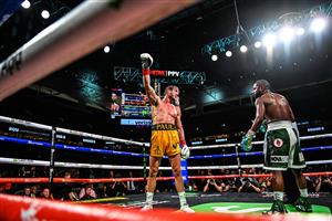 YouTube personality Logan Paul raises his glove as he fights Former world welterweight king Floyd Mayweather (R) in an eight-round exhibition bout at Hard Rock Stadium in Miami, Florida on June 6, 2021. (Getty Images)