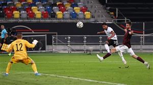 DUESSELDORF, GERMANY - JUNE 07: Serge Gnabry of Germany scores their sides fifth goal past Roberts Ozols of Latvia during the international friendly match between Germany and Latvia at Merkur Spiel-Arena on June 07, 2021 in Duesseldorf, Germany. (Getty Images)