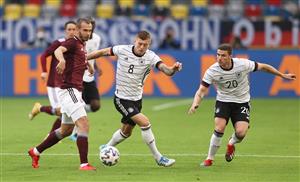 DUESSELDORF, GERMANY - JUNE 07: Arturs Zjuzins of Latvia battles for possession with Toni Kroos and Robin Gosens of Germany during the international friendly match between Germany and Latvia at Merkur Spiel-Arena on June 07, 2021 in Duesseldorf, Germany. (Getty Images)