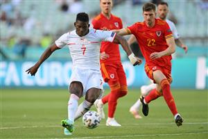 Switzerland's forward Breel Embolo (L) attempts a shot as he is marked by Wales' defender Chris Mepham during the UEFA EURO 2020 Group A football match between Wales and Switzerland at the Olympic Stadium in Baku on June 12, 2021. (Getty Images)