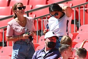 Coleen Rooney (L) chats with Annie Kilner (back R) past former English football player Wayne Rooney as they wait for the UEFA EURO 2020 Group D football match between England and Croatia at Wembley Stadium in London on June 13, 2021. (Getty Images)