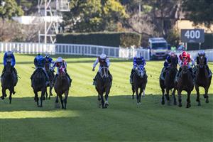 SYDNEY, AUSTRALIA - JUNE 12: Reece Jones (red and white cap) on Opacity wins race 6 the Heineken Racing To Win Handicap during Sydney Racing at Royal Randwick Racecourse on June 12, 2021 in Sydney, Australia. (Photo by Jenny Evans/Getty Images)