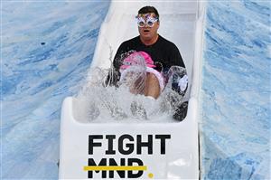 MELBOURNE, AUSTRALIA - JUNE 14: Shane Crawford goes down the slide during the Big Freeze slide at Melbourne Cricket Ground on June 14, 2021 in Melbourne, Australia. The annual event aims to raise funds to fight MND as part of the Queen's Birthday AFL match, this year held at the SCG due to Covid19 protocols in Melbourne preventing crowd from attending this year's event. (Photo by Quinn Rooney/Getty Images)