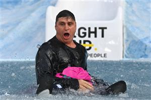 MELBOURNE, AUSTRALIA - JUNE 14: Shane Crawford goes down the slide during the Big Freeze slide at Melbourne Cricket Ground on June 14, 2021 in Melbourne, Australia. The annual event aims to raise funds to fight MND as part of the Queen's Birthday AFL match, this year held at the SCG due to Covid19 protocols in Melbourne preventing crowd from attending this year's event. (Photo by Quinn Rooney/Getty Images)
