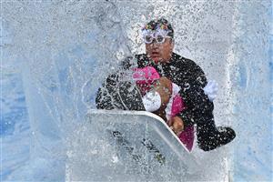 MELBOURNE, AUSTRALIA - JUNE 14: Shane Crawford goes down the slide during the Big Freeze slide at Melbourne Cricket Ground on June 14, 2021 in Melbourne, Australia. The annual event aims to raise funds to fight MND as part of the Queen's Birthday AFL match, this year held at the SCG due to Covid19 protocols in Melbourne preventing crowd from attending this year's event. (Photo by Quinn Rooney/Getty Images)