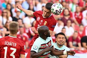 Hungary's forward Roland Sallai (TOP) heads the ball over Portugal's midfielder Danilo Pereira and Portugal's defender Raphael Guerreiro (R) during the UEFA EURO 2020 Group F football match between Hungary and Portugal at the Puskas Arena in Budapest on June 15, 2021. (Getty Images)