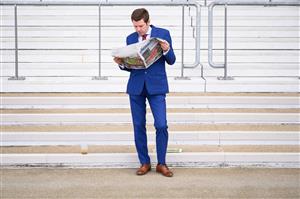 ASCOT, ENGLAND - JUNE 15: A race-goer studies the odds ahead of the first race at Ascot Racecourse on June 15, 2021 in Ascot, England. 12,000 spectators are being allowed to attend each day of the five-day meeting, with racegoers providing negative Covid-19 tests to gain admission. (Photo by Leon Neal/Getty Images)