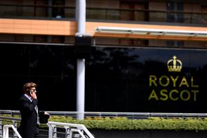 ASCOT, ENGLAND - JUNE 16: A racegoer looks on whilst using their mobile phone on Day Two of the Royal Ascot Meeting at Ascot Racecourse on June 16, 2021 in Ascot, England. A total of twelve thousand racegoers made up of Owners and the Public are permitted to attend the meeting due to it being an Events Research Programme (ERP) set up by the government due to the Coronavirus Pandemic. (Photo by Harry Trump/Getty Images)