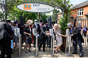 ASCOT, ENGLAND - JUNE 15: Race-goers wearing protective facial masks enter the grounds at Ascot Racecourse on June 15, 2021 in Ascot, England. 12,000 spectators are being allowed to attend each day of the five-day meeting, with racegoers providing negative Covid-19 tests to gain admission. (Photo by Leon Neal/Getty Images)