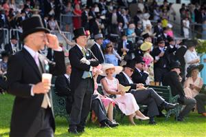 ASCOT, ENGLAND - JUNE 15: Race-goers gather ahead of the third race at Ascot Racecourse on June 15, 2021 in Ascot, England. 12,000 spectators are being allowed to attend each day of the five-day meeting, with racegoers providing negative Covid-19 tests to gain admission. (Photo by Leon Neal/Getty Images)