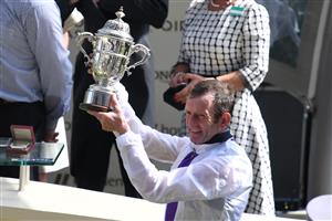 Jockey Kevin Manning holds up the trophy after winning the St James Palace Stakes at Ascot Racecourse on June 15, 2021 in Ascot, England. (Getty)