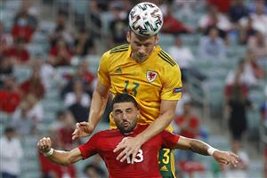 TOPSHOT - Wales' midfielder Kieffer Moore (TOP) heads the ball over Turkey's defender Umut Meras during the UEFA EURO 2020 Group A football match between Turkey and Wales at the Olympic Stadium in Baku on June 16, 2021. (Getty Images)