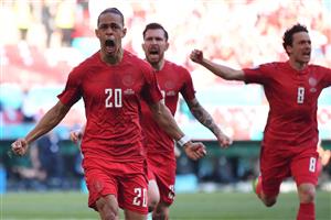 Denmark's forward Yussuf Poulsen (L) celebrates with teammates after scoring the team's first goal during the UEFA EURO 2020 Group B football match between Denmark and Belgium at the Parken Stadium in Copenhagen on June 17, 2021. (Getty Images)