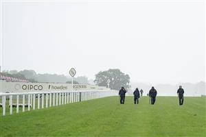 ASCOT, ENGLAND - JUNE 18: Groundstaff tread the divots back in on a wet day on Day Four of the Royal Ascot Meeting at Ascot Racecourse on June 18, 2021 in Ascot, England. A total of twelve thousand racegoers made up of owners and the public are permitted to attend the meeting due to it being an Events Research Programme (ERP) set up by the Government due to the Coronavirus pandemic. (Photo by Alan Crowhurst/Getty Images)