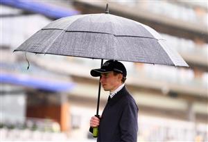 ASCOT, ENGLAND - JUNE 18: Jockey Ryan Moore looks on as heavy rain falls on Day Four of the Royal Ascot Meeting at Ascot Racecourse on June 18, 2021 in Ascot, England. A total of twelve thousand racegoers made up of Owners and the Public are permitted to attend the meeting due to it being an Events Research Programme (ERP) set up by the government due to the Coronavirus Pandemic. (Photo by Harry Trump/Getty Images)