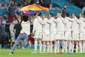 A person waving the rainbow flag runs on the pitch as the players line up for the national anthems the UEFA EURO 2020 Group F football match between Germany and Hungary at the Allianz Arena in Munich on June 23, 2021. (Getty Images)
