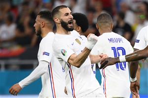 TOPSHOT - France's forward Karim Benzema celebrates with teammates after scoring a penalty during the UEFA EURO 2020 Group F football match between Portugal and France at Puskas Arena in Budapest on June 23, 2021. (Getty Images)