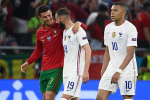 Portugal's forward Cristiano Ronaldo and France's forward Karim Benzema walk together off the pitch in half-time of the UEFA EURO 2020 Group F football match between Portugal and France at Puskas Arena in Budapest on June 23, 2021. (Getty Images)