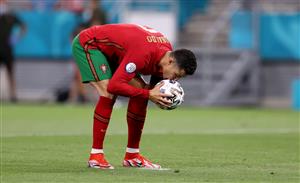 BUDAPEST, HUNGARY - JUNE 23: Cristiano Ronaldo of Portugal kisses the ball before taking a penalty during the UEFA Euro 2020 Championship Group F match between Portugal and France at Puskas Arena on June 23, 2021 in Budapest, Hungary. (Getty Images)