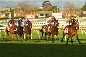 MELBOURNE, AUSTRALIA - JUNE 26: Lachlan King riding No Effort winning Race 7, the Neds Same Race Multi Handicap, during Melbourne Racing at Caulfield Racecourse on June 26, 2021 in Melbourne, Australia. (Photo by Vince Caligiuri/Getty Images)