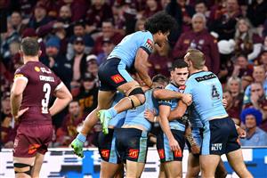 BRISBANE, AUSTRALIA - JUNE 27: Tom Trbojevic of the Blues celebrates with team mates after scoring a try during game two of the 2021 State of Origin series between the Queensland Maroons and the New South Wales Blues at Suncorp Stadium on June 27, 2021 in Brisbane, Australia. (Photo by Bradley Kanaris/Getty Images)