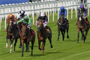 ESHER, ENGLAND - JULY 02: Jason Watson riding Vino Victrix (green) win The Davies Group Handicap at Sandown Racecourse on July 02, 2021 in Esher, England. Due to the Coronavirus pandemic, only owners along with a limited number of the paying public will be allowed to attend the meeting. (Photo by Alan Crowhurst/Getty Images)