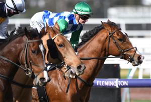 MELBOURNE, AUSTRALIA - JULY 03: Jamie Kah riding Grand Promenade winning Race 3, the Lexus Banjo Paterson Series Final, during Melbourne Racing at Flemington Racecourse on July 03, 2021 in Melbourne, Australia. (Photo by Vince Caligiuri/Getty Images)
