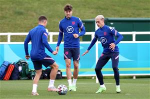 BURTON UPON TRENT, ENGLAND - JULY 05: Kieran Trippier of England controls the ball as John Stones and Phil Foden watch on during the England Training Session at St George's Park on July 05, 2021 in Burton upon Trent, England. (Getty Images)