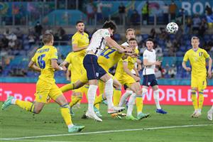 TOPSHOT - England's defender Harry Maguire heads the ball to score the team's second goal during the UEFA EURO 2020 quarter-final football match between Ukraine and England at the Olympic Stadium in Rome on July 3, 2021. (Getty Images)