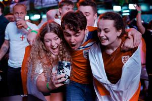 England supporters celebrate victory at the final whistle of the UEFA EURO 2020 semi-final football match between England and Denmark, at Boxpark Croydon in south London on July 7, 2021. (Getty Images)