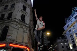 An England supporter celebrates victory on a lampost following the UEFA EURO 2020 semi-final football match between England and Denmark, in Piccadilly, central London on July 7, 2021. (Getty Images)
