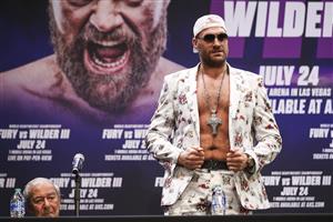 LOS ANGELES, CALIFORNIA - JUNE 15: Tyson Fury puts on a jacket during the press conference with Deontay Wilder at The Novo by Microsoft at L.A. Live on June 15, 2021 in Los Angeles, California. (Getty Images)